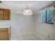 Small dining area with tiled floor and a stained-glass chandelier at 7719 Cosme Dr # 1, Hudson, FL 34667