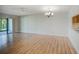 Spacious living area with wood-look floors and access to a relaxing patio at 7719 Cosme Dr # 1, Hudson, FL 34667