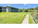 Condo building with a pond view and walkway at 7719 Cosme Dr # 1, Hudson, FL 34667