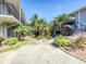 Community courtyard with tropical landscaping and seating areas at 7719 Cosme Dr # 1, Hudson, FL 34667