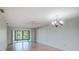 Bright living room featuring wood flooring and sliding glass doors leading to a patio at 7719 Cosme Dr # 1, Hudson, FL 34667