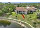 Lakeside condo with a screened lanai and manicured lawn at 7719 Cosme Dr # 1, Hudson, FL 34667