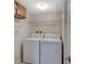 Convenient laundry area with washer, dryer, and overhead shelving at 7719 Cosme Dr # 1, Hudson, FL 34667