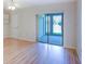 Bedroom with wood-look floors and sliding doors to patio at 7719 Cosme Dr # 1, Hudson, FL 34667