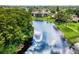 Aerial view of community with lake and lush landscaping at 7719 Cosme Dr # 1, Hudson, FL 34667