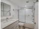 Clean bathroom with a tub shower combo, updated vanity, and tiled flooring at 7719 Cosme Dr # 1, Hudson, FL 34667