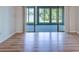 Bright room featuring gleaming laminate flooring and sliding doors opening to the lanai at 7719 Cosme Dr # 1, Hudson, FL 34667