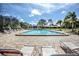 Community pool with plenty of lounge chairs at 7719 Cosme Dr # 1, Hudson, FL 34667