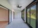 Sunroom with gray carpeting, ceiling fan, and sliding glass doors at 7719 Cosme Dr # 1, Hudson, FL 34667