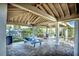 Covered patio with picnic table and seating at 7719 Cosme Dr # 1, Hudson, FL 34667