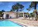 Relaxing community pool area with patio furniture at 7719 Cosme Dr # 1, Hudson, FL 34667