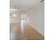 Open living room with hardwood floors, showcasing views of the kitchen and entryway at 7719 Cosme Dr # 1, Hudson, FL 34667