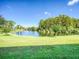 Serene waterfront view with lush greenery and walking path at 7719 Cosme Dr # 1, Hudson, FL 34667