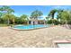 Community pool with lounge chairs and covered patio at 7719 Cosme Dr # 1, Hudson, FL 34667