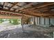 Garage interior requiring renovation, showing exposed beams and flooring at 9305 Kiowa Dr, New Port Richey, FL 34654
