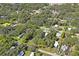 Aerial view showing home's location in a residential neighborhood with lush greenery at 9305 Kiowa Dr, New Port Richey, FL 34654