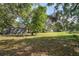 Spacious lot with shed and mature trees, offering ample outdoor space at 9305 Kiowa Dr, New Port Richey, FL 34654