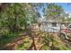 House exterior featuring a carport, mature trees and a fenced yard at 9305 Kiowa Dr, New Port Richey, FL 34654