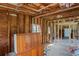 Home interior undergoing renovation, showing exposed framing and existing cabinetry at 9305 Kiowa Dr, New Port Richey, FL 34654