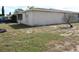 Landscaped side yard with some patchy grass areas at 7204 Westcott Dr, Port Richey, FL 34668