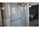 Bathroom with shower and view into bedroom at 7204 Westcott Dr, Port Richey, FL 34668