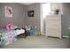 Bedroom with twin bed, dresser, and window at 7204 Westcott Dr, Port Richey, FL 34668