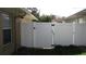 White vinyl fence encloses a small backyard at 18516 Avocet Dr, Lutz, FL 33558