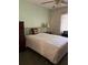Bright bedroom with double bed, dresser, and ceiling fan at 7486 Heather Walk Dr # 31, Weeki Wachee, FL 34613