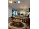 Open living room with ample seating, coffee table, and view to dining area at 7486 Heather Walk Dr # 31, Weeki Wachee, FL 34613