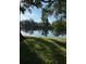 Peaceful lake view with lush greenery and tree-lined shores at 7486 Heather Walk Dr # 31, Weeki Wachee, FL 34613