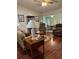 Spacious living room with hardwood floors, comfy seating, and views to dining area at 7486 Heather Walk Dr # 31, Weeki Wachee, FL 34613