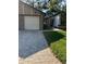 Exterior view of a villa with a brick facade, attached garage, and landscaped lawn at 7486 Heather Walk Dr # 31, Weeki Wachee, FL 34613