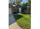 Inviting exterior of a single-story home with a well-maintained lawn and paved walkway at 7486 Heather Walk Dr # 31, Weeki Wachee, FL 34613