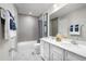 Clean bathroom with double vanity, white cabinets, and a bathtub at 10421 High Noon Trl, Parrish, FL 34219
