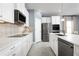 Spacious kitchen boasts white cabinets, stainless steel appliances, and patterned backsplash at 10421 High Noon Trl, Parrish, FL 34219