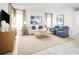 Living area with comfy seating, large windows, and stylish decor at 10421 High Noon Trl, Parrish, FL 34219