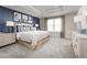 Large main bedroom with a king-size bed, a dresser, and blue accent wall at 10421 High Noon Trl, Parrish, FL 34219