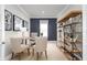 Home office with a large desk, two chairs, and built-in shelving at 10421 High Noon Trl, Parrish, FL 34219