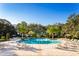 Large community pool surrounded by lounge chairs at 10421 High Noon Trl, Parrish, FL 34219
