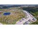 Aerial view of houses and a pond nestled in a wooded area at 11389 Weaver Hollow Rd, New Port Richey, FL 34654