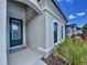 Inviting front entrance with a dark blue door and decorative glass at 11389 Weaver Hollow Rd, New Port Richey, FL 34654