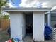 White storage shed with bicycle and yard tools at 11614 Zimmerman Rd, Port Richey, FL 34668