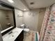 Bathroom with toilet, sink, shower, and nautical decor at 11614 Zimmerman Rd, Port Richey, FL 34668