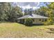 Side view of house with metal roof and large backyard at 13080 Old Crystal River Rd, Brooksville, FL 34601