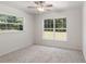 Bright bedroom with new carpet, large windows, and ceiling fan at 13080 Old Crystal River Rd, Brooksville, FL 34601