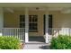 Front porch with white columns and railing at 13080 Old Crystal River Rd, Brooksville, FL 34601