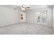 Bright bedroom with carpeted floors, ceiling fan and access to kitchen at 13080 Old Crystal River Rd, Brooksville, FL 34601
