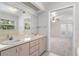 Double vanity bathroom with a tub and access to another room at 13080 Old Crystal River Rd, Brooksville, FL 34601