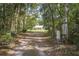 House driveway entrance through wooded area at 13080 Old Crystal River Rd, Brooksville, FL 34601