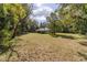 House surrounded by lush greenery and trees at 13080 Old Crystal River Rd, Brooksville, FL 34601